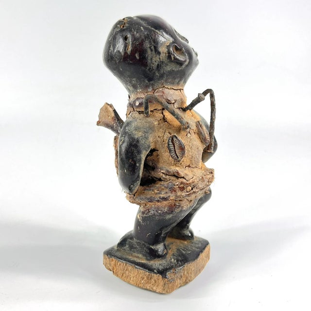The Kongo Nkisi Nkondi Power Fetish Figure from Congo is a striking, handcrafted spiritual object used in rituals to...