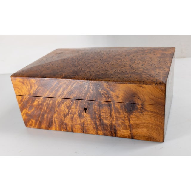 We are selling this very pretty Burlwood box. This Jewelry or Dresser box appears to be made of Thuya burlwood. The top...