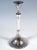 Two elegant silver candlesticks on a round base, guilloché pattern on the side of the base, raised shaft in the centre,...