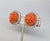 1950s rhodium plated round carved faux-coral center with round clear rhinestone surround clip earrings. Marked "KRAMER NEW...