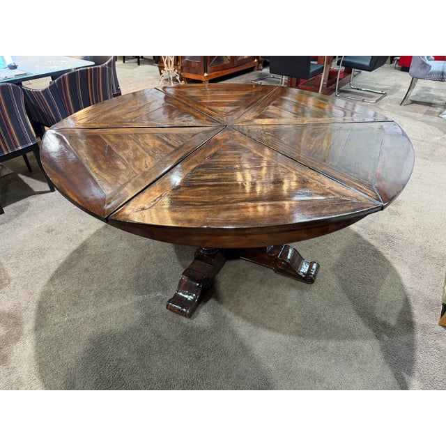 A striking blend of rustic character and refined craftsmanship, this Theodore Alexander expandable dining table makes a...
