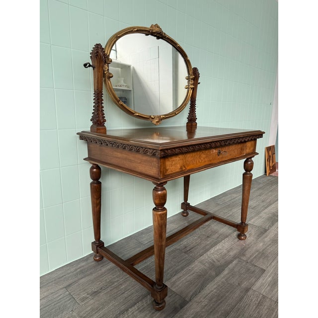 Antique dressing table made in the 1930s and 1940s in an antique style. Featuring an elegant adjustable oval mirror framed...