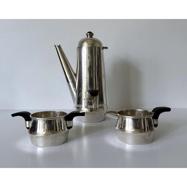 A lovely set of coffee service consisting of a large coffee pot, a sugar and a creamer (this set is of the largest size of...