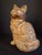 Exhibiting exceptional sculptural presence, this antique cast iron doorstop captures a seated fluffy cat rendered with...