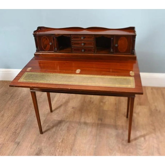 A delightful Sheraton style ladies desk dating to 1890 Rich flame mahogany wood with deep patina Sheraton style tapering...