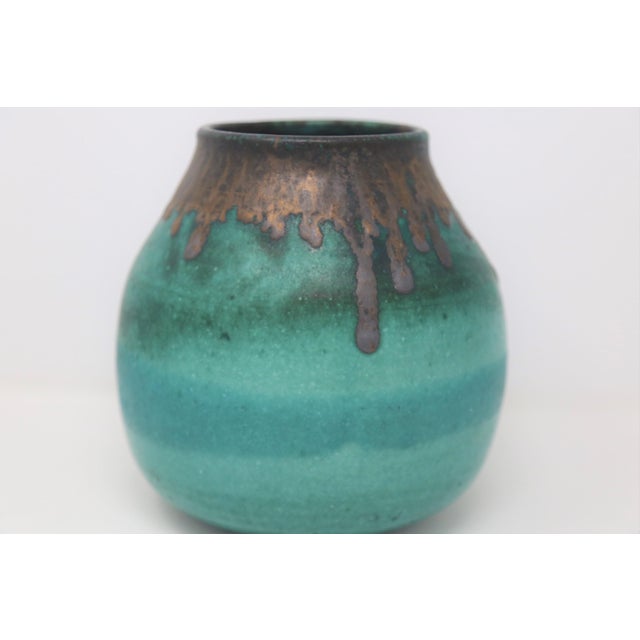 A beautifully proportioned studio pottery vase featuring a rich teal-green glaze with layered tonal depth and a dramatic...