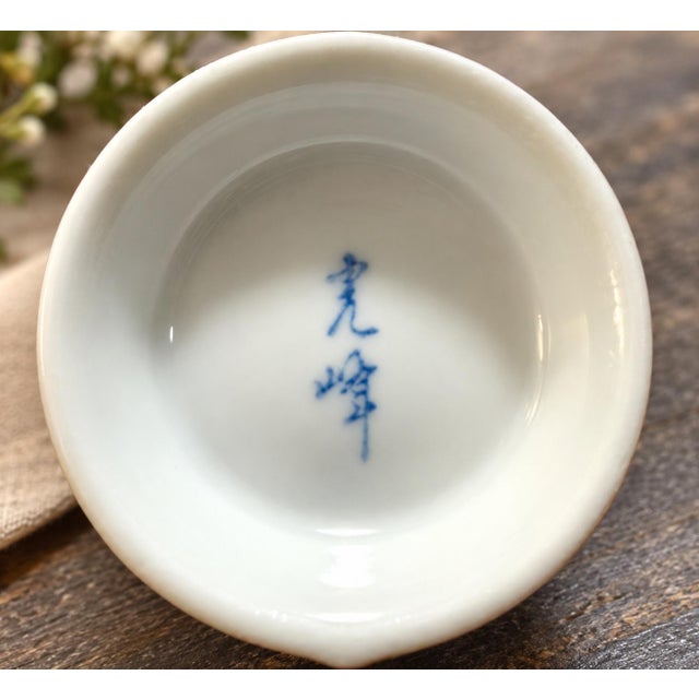 Beautiful vintage Japanese porcelain bud vase featuring a delicate hydrangea floral design in soft, muted shades of blue,...