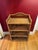 Beautiful vintage wicker etagere with four shelves. This lovely wicker piece features arched detail to back, intricate...