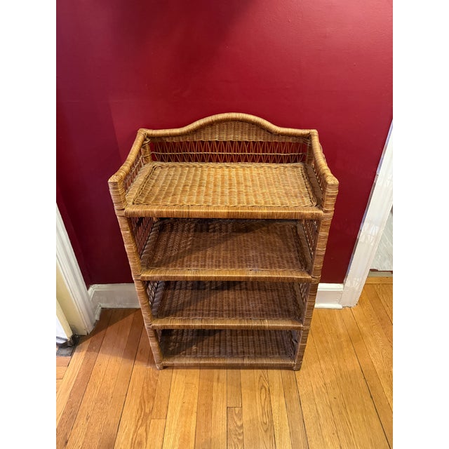 Beautiful vintage wicker etagere with four shelves. This lovely wicker piece features arched detail to back, intricate...