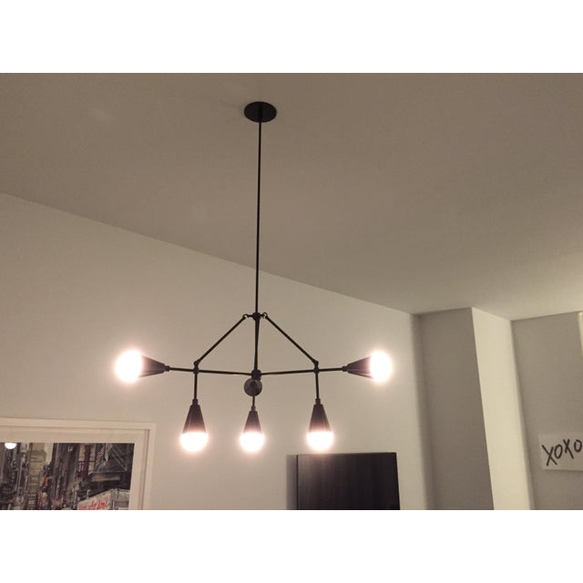 Iconic Apparatus brand lighting fixture. 6 Pendant triad 40inches. Current retail is 7800. Cloud bulbs with blackened...
