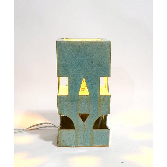 Part of the Cloister lamp series, this compact architectural form explores how geometric openings create passages for...