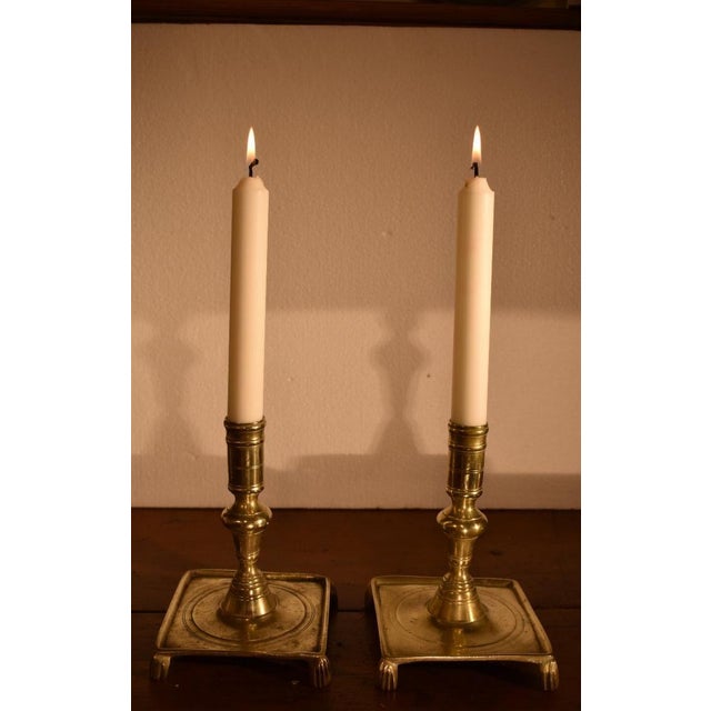 Early pair of brass candlesticks, circa 1690 of Spanish or Dutch origin. The baluster stem is above a ring, centering on a...