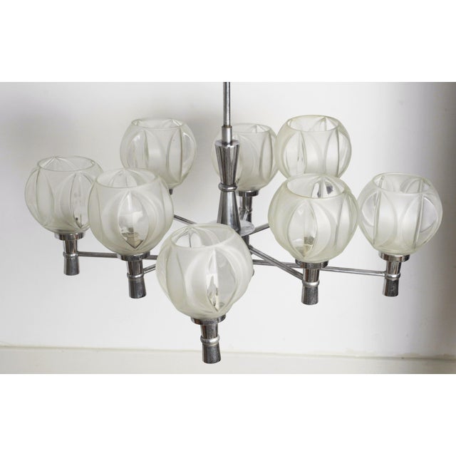 Vintage sputnik chandelier with eight radial chrome-plated steel arms and hand-blown faceted glass globes, with mid-...