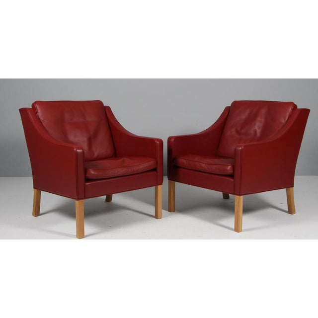 Børge Mogensen lounge chair original upholstered with red leather. Legs of oak. Model 2207, made by Fredericia furniture....