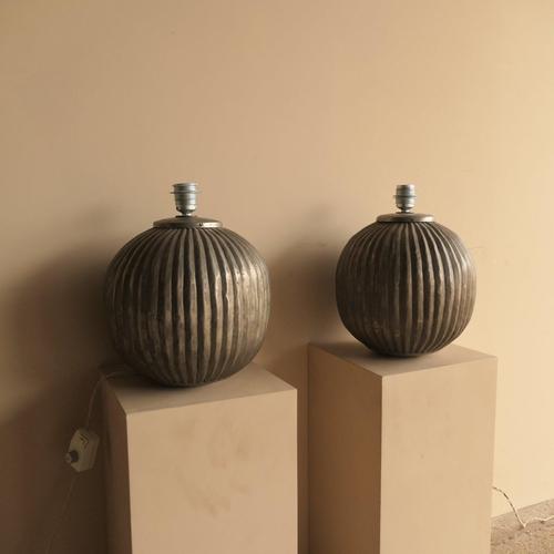 Pair of highly decorative art deco lamps with hand beaten embossed ribbing that gives a rustic feel. Sourced in France,...