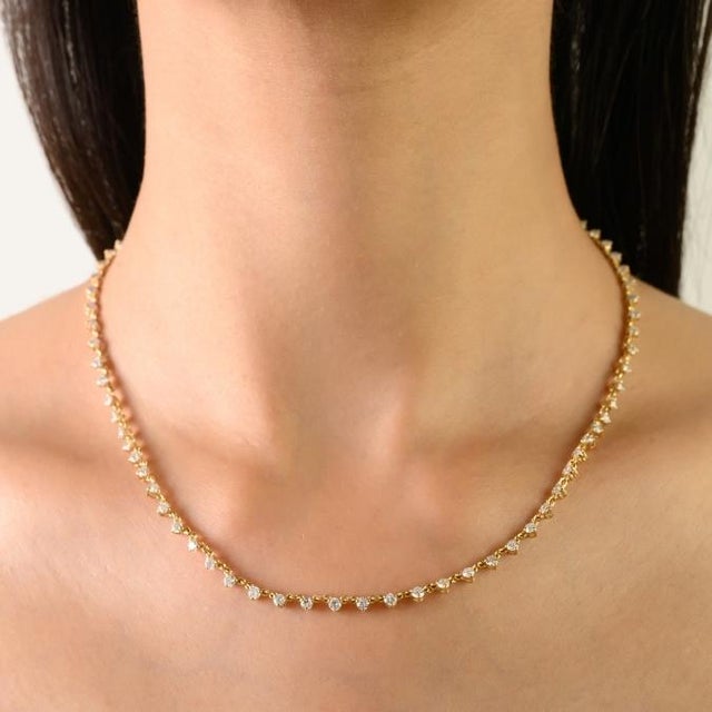 This elegant diamond station necklace features round cut diamond totaling 3.6 carats, set in 18k Yellow Gold each diamond...