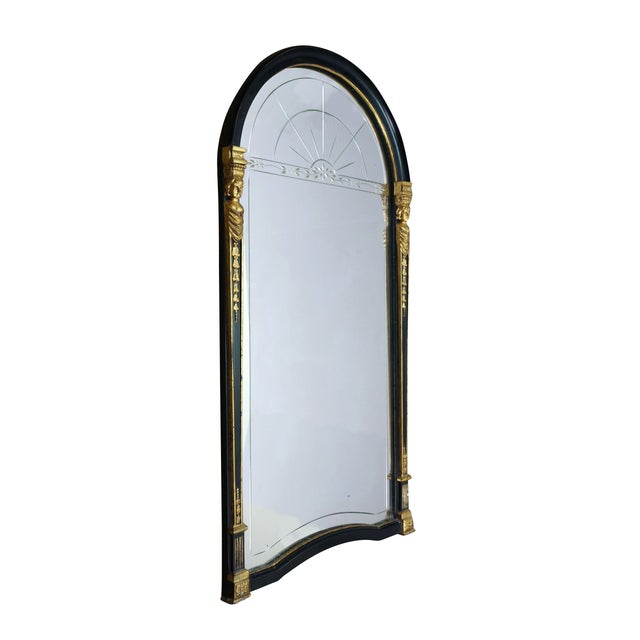 This elegant Antique Empire or Egyptian Revival wall mirror features a striking arched top, a curved bottom edge, and a...