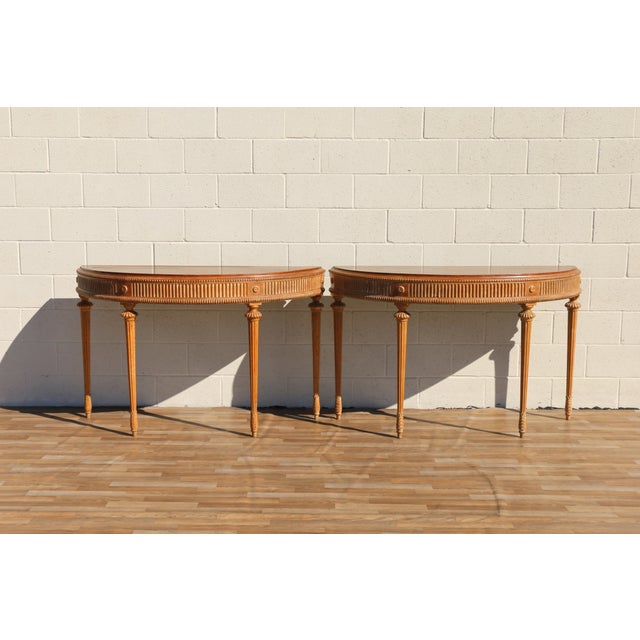 Beautiful antique pair of demi-lune console tables from the 1920s, crafted from solid fruitwood and featuring elegant...