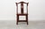 Chinese dining room chair made in solid wood skied completely in reddish tone with decoration in gold in backrest and skirt.