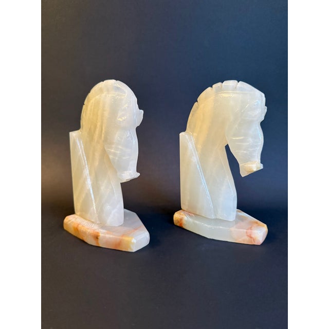 Beautiful pair of white stone onyx Horse head bookends on a sturdy, orange striated marble base. Likely crafted in the mid...