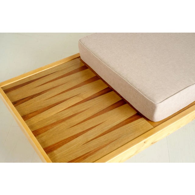 Beech daybed, France 1950. The top consists of an oak veneered part and a shelf inlaid with opposing triangles in light...