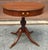 A 1940s Georgian-style Mahogany Drum Table with a Single Drawer and Brass Hardware on a pedestal quadpod Pedestal....