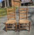 A lovely pair of antique Shaker-style ladder-back chairs with woven or splint seats, likely dating from the late 19th to...