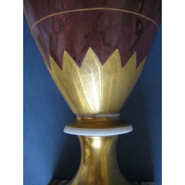 Early 19th century old Paris porcelain urn decorated in a classical motif enhanced by gilding. Empire taste with lion head...