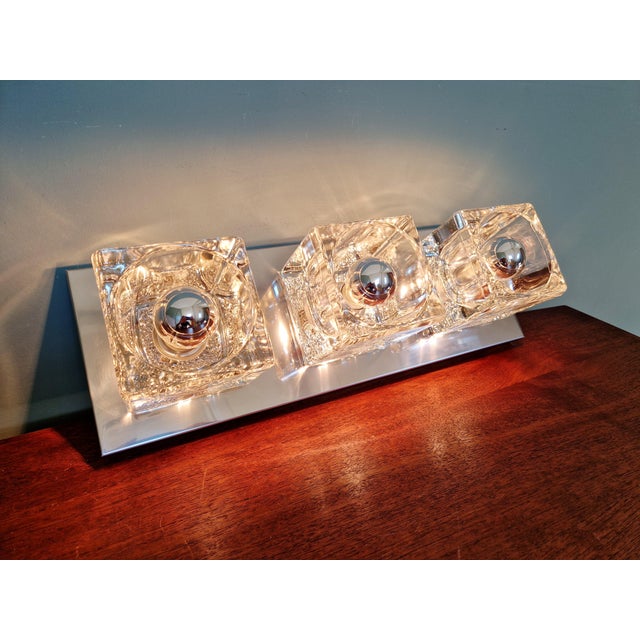 Double wall sconce in chrome-plated metal and ice cube glass, produced by the german manufacturer peill & putzler, 1970s....