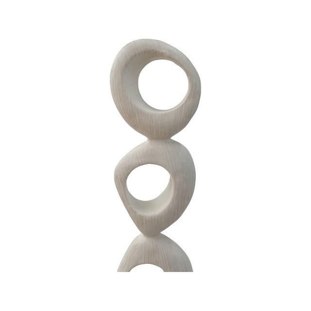 Modern and sculptural, this abstract stacked-ring sculpture adds height, texture, and visual intrigue to any space....