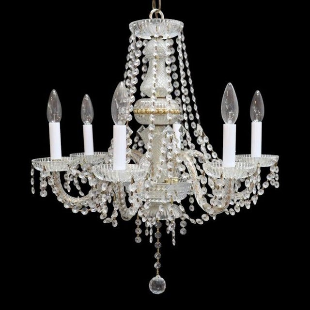 This vintage chandelier, dating to approximately 1940, features a six-light design crafted from a combination of crystal,...