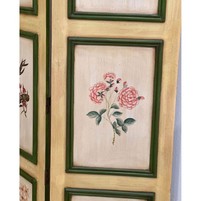 A quietly enchanting statement piece, this vintage folding screen features a series of delicately hand-painted botanical...