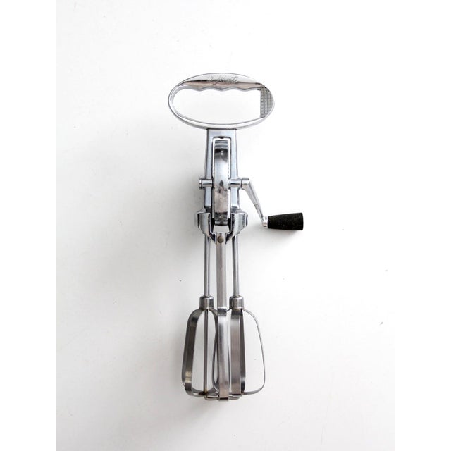 This vintage Flint egg beater from the 1940s to 1950s is a timeless example of mid century American kitchen design....