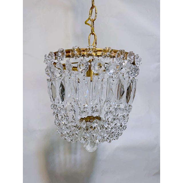 A beautiful vintage crystal chandelier that combines timeless European elegance with Hollywood Regency glamour. Featuring...
