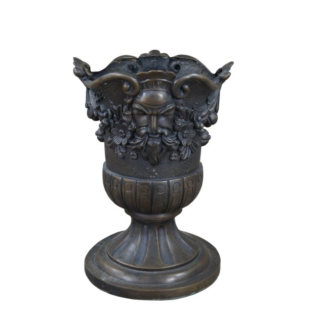 A beautiful figured bronze urn or planter. Features a traditional Grecian form with a lobed body and round fluted base....