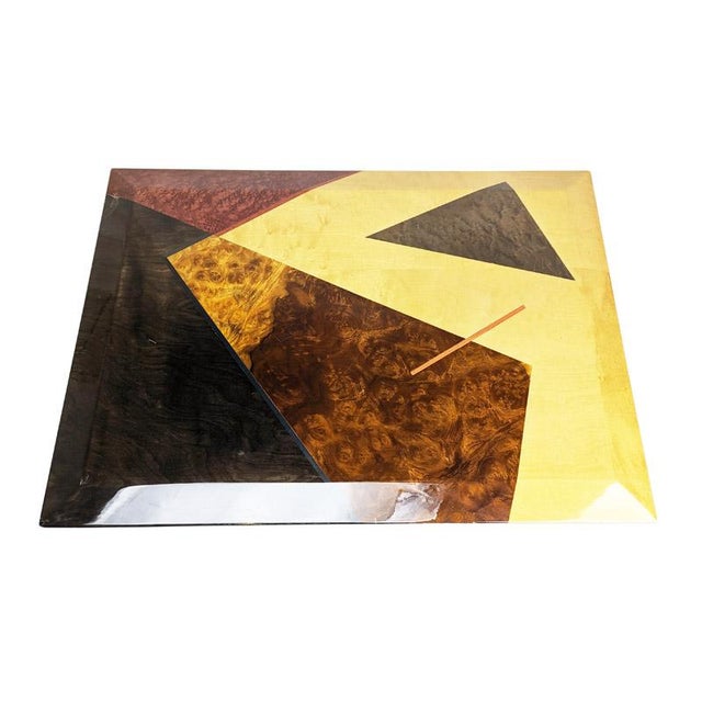 Rare coffee table with wooden top with geometric colored inlays and base in craquelè painted metal. The top, bevelled on 4...