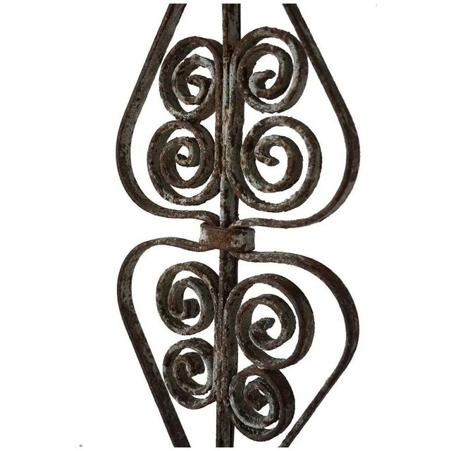 DETAILS This decorative lamp was custom made from an antique hand forged iron baluster. It was formed in opposing urn...