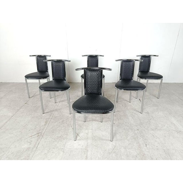 Set of 6 post modern dining chairs with a striking design with chrome frames and skai upholstery with a cool pattern. Good...
