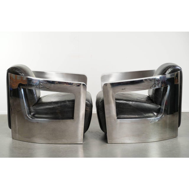 This industrial set of two black cowhide Aviator-style armchairs has a rugged look thanks to the sides, which are trimmed...