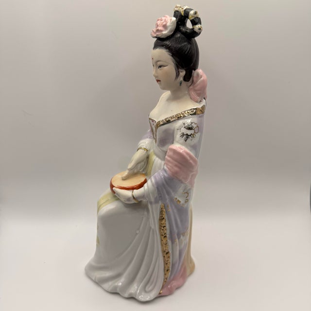 Beautiful Chinese porcelain depicting a Japanese Geisha inspired Asian lady playing a shougu (hand drum). Mid century...