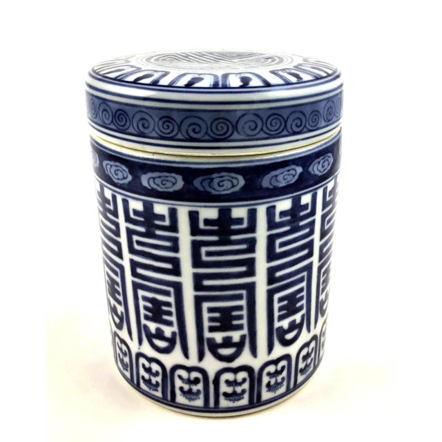 Hand painted blue and white traditional design on a large heavy covered round container. The lid has Chinese calligraphy...