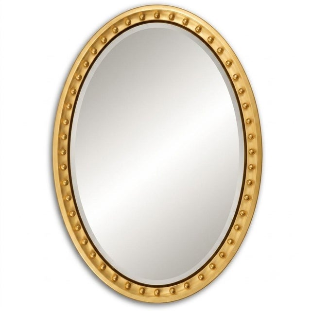 The Thomkins Tavern centers a serene oval mirror within a beaded gold rectangular frame, marrying two classical shapes...