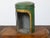 An English Parnall & Son green painted metal tea box from the 19th century with gilt painted floral frieze, glass front...