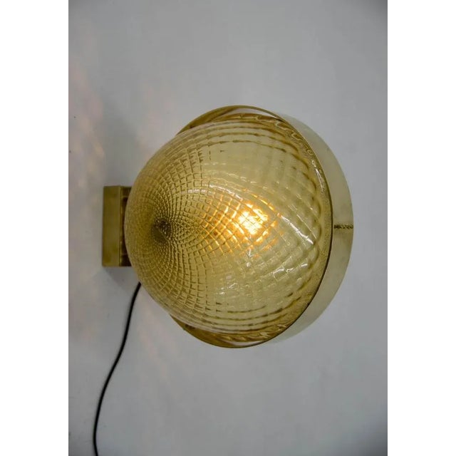 Mid-century modern wall lamp made of blown glass and polished brass. Four items available. Very good original condition....