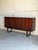 This architectural highboard features a long geometric chassis elevated by an iconic open sled base. Smooth sliding doors...