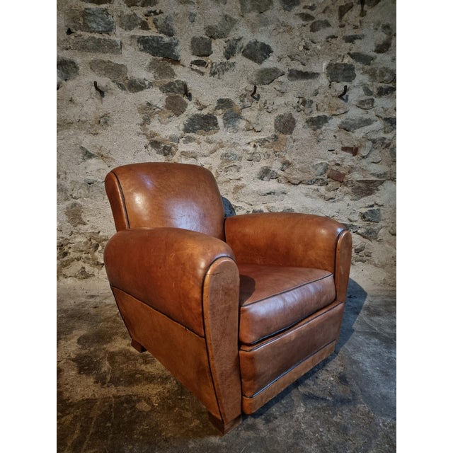 This vintage French leather club chair was produced in France during the 1940s–1950s and exemplifies the classic Art...