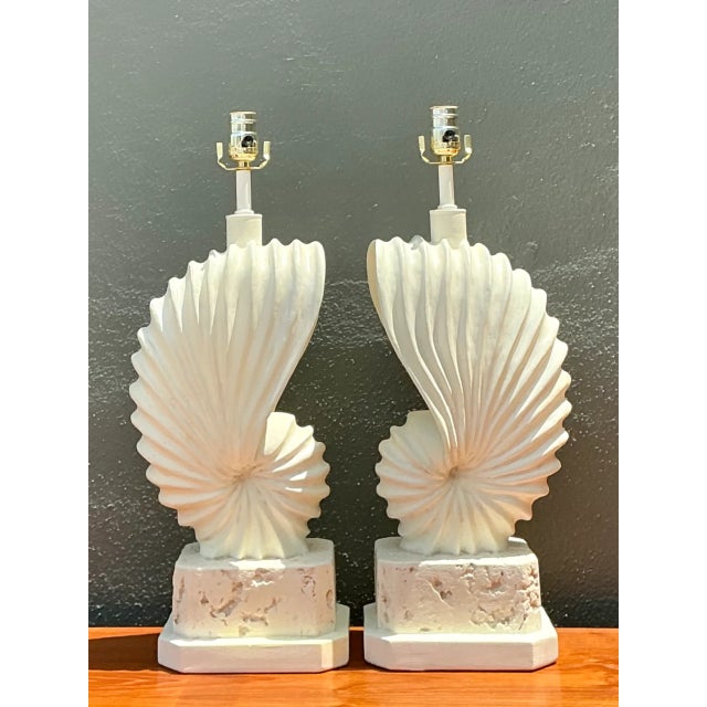 This pair of vintage plaster table lamps embodies mid-century modern sculptural design, their shell-form bodies spiraling...