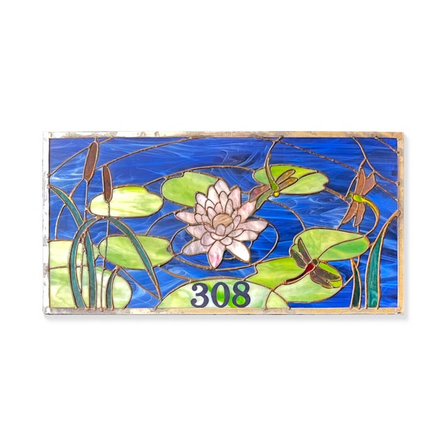 Add a splash of timeless charm to your home with this handcrafted stained glass transom window, featuring a serene aquatic...