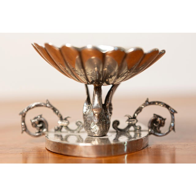 This exquisite 19th-century French silver sculpture is a finely crafted decorative piece featuring an elegant swan motif....