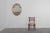 This 20th‑century oval mirror by Deknudt reflects the refined elegance of Neo‑Classical design, interpreted through the...